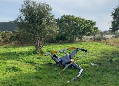 The accident helicopter wrecked at the accident site, a paddock adjoining the Arapito River. Photo: NZ Police