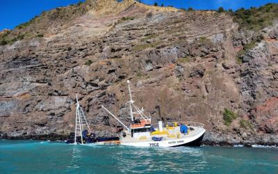 The Austro Carina fishing vessel at the accident site. The vessel lies aground with its right rear quarter under water.