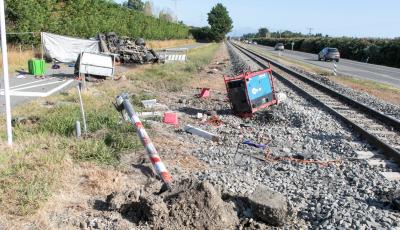 Fig 7 from the Final Report. Lights and bells wrecked in foreground, Truck top left. Photo - NZ Police. photo of the accident scene