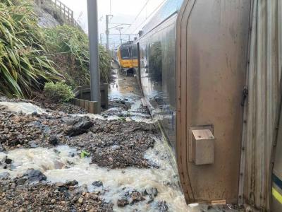 Photo: The accident train embedded in landslip debris and flowing water