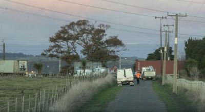 Photo from a distance show the stationary freight train and the remains of the truck at the accident site