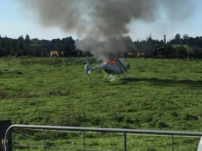 The burning helicopter at the site soon after landing. Photo by permission