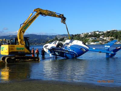 The helicopter being lifted out of the harbour