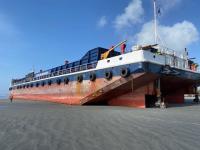 The barge Manahau aground on Carters Beach. | TAIC photo The barge lies embedded in the beach