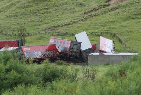 Derailed wagons lie toppled at the accident site
